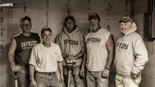 McCoy Contractors foreman and experienced crew in basement showcasing foundation repair expertise Milwaukee