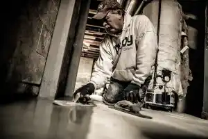 McCoy Contractors, Inc. - Foreman troweling new drain tile concrete