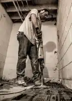 McCoy Contractors, Inc. - Jack hammer concrete for drain tile